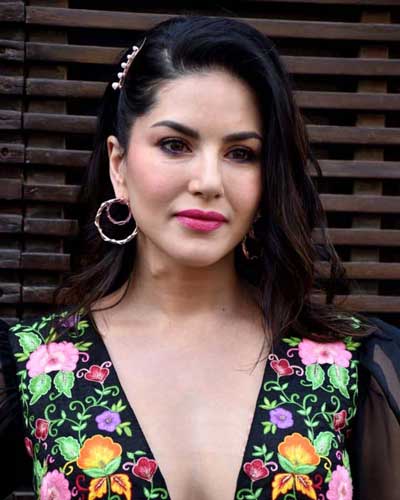  A close-up photo of Sunny Leone, her expression pensive and engaging, suggesting deep thought and intellectual curiosity.