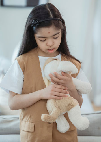 Autistic child playing with soft toy
